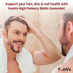 YUM-V'S Biotin Gummies on hand show a chewy texture for an easy daily routine.