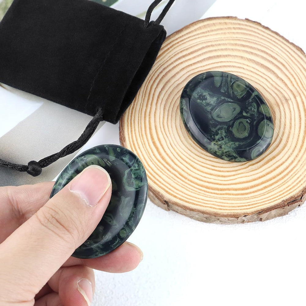 Yuntop Kambaba Jasper thumb worry stone on desk, ideal for desk breaks and focus.