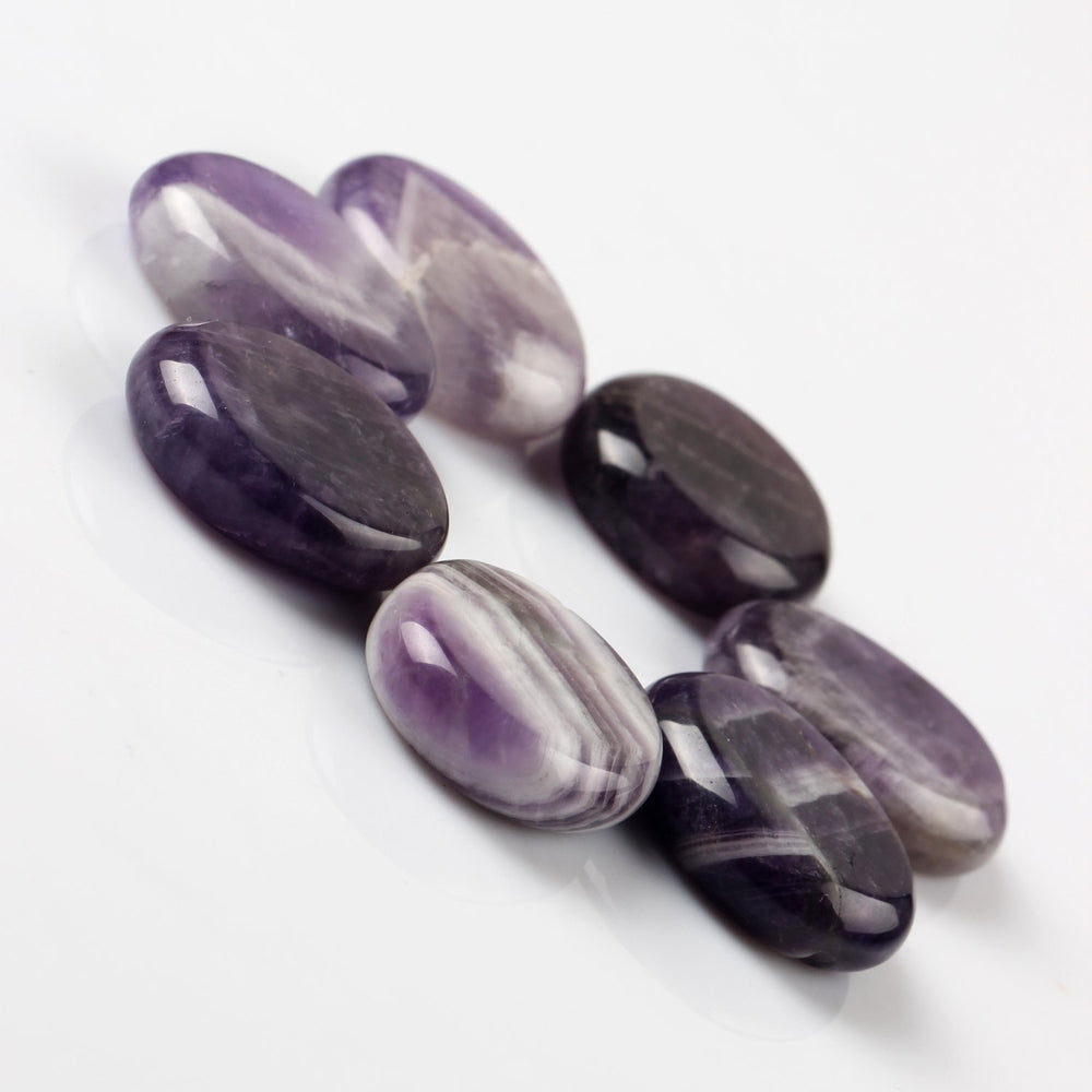 YWG Stone Amethyst palm stone showing smooth polished surface for on-the-go use