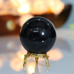 ZAICUS obsidian sphere on metal stand enhances calm workspaces and focus.