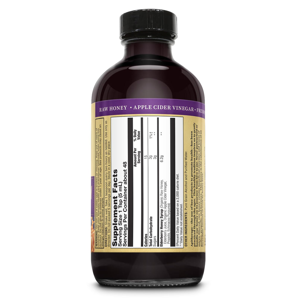 Pouring ZAND Honey Gardens Elderberry Syrup shows smooth consistency and deep hue.
