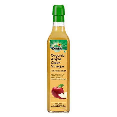 Zandu Organic Apple Cider with Mother in bottle on counter, ideal for dressings.
