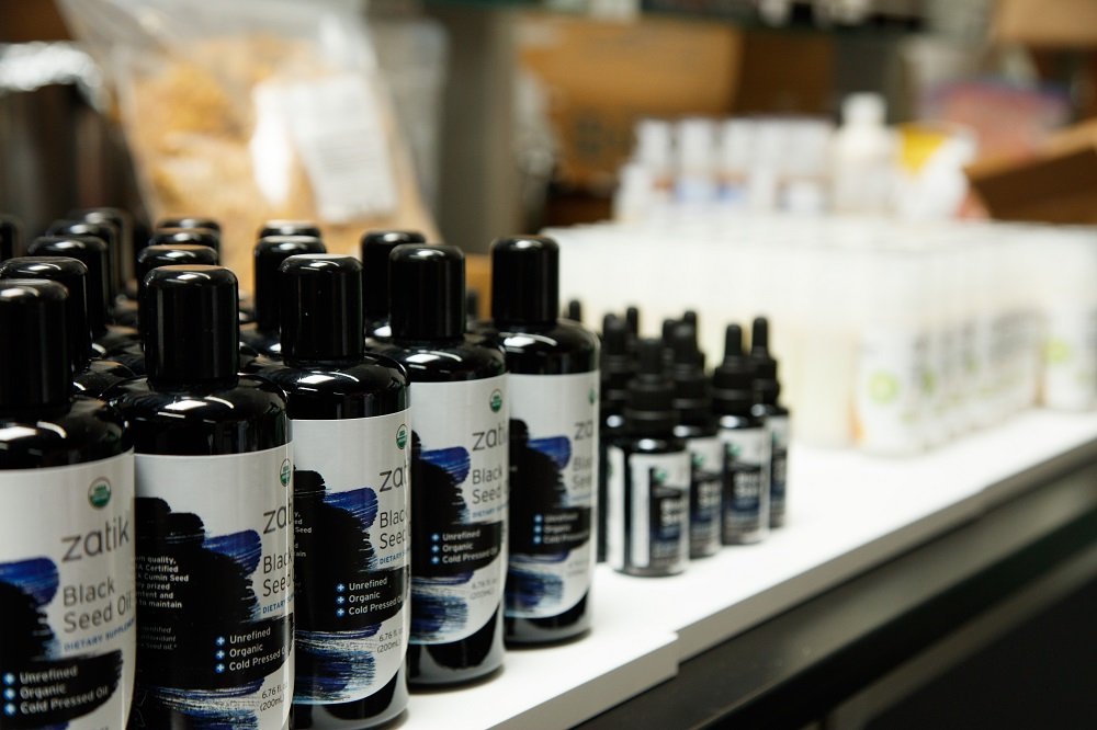 Zatik Black Seed Oil on skin; suitable for self-care routines.