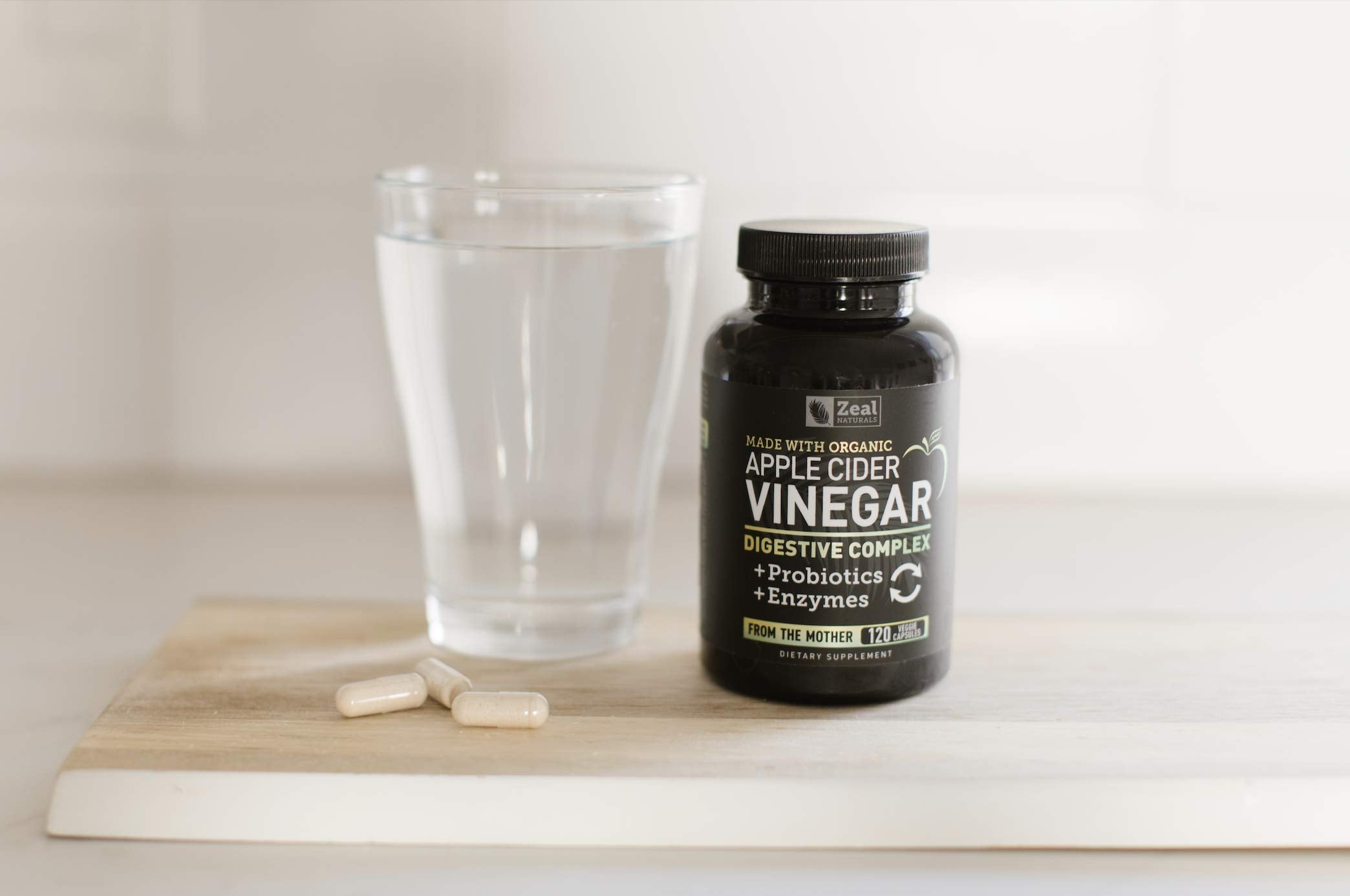 Zeal Naturals daily use scene with capsules and water for gut health