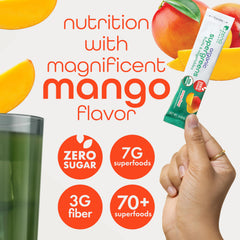 Mango flavored greens powder poured into a glass.