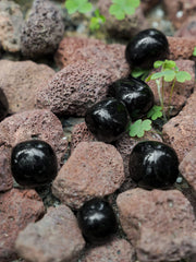 ZenQ obsidian stones close-up, showing smooth polish and natural texture.