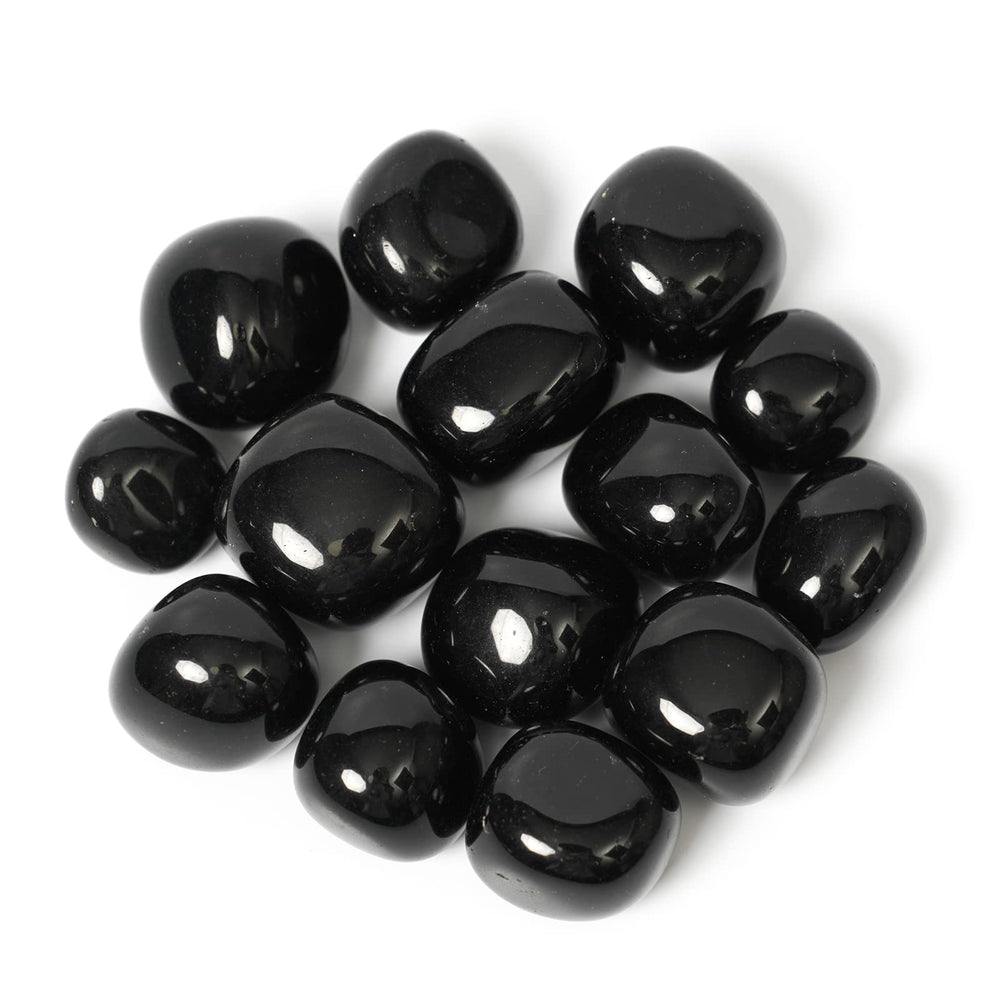 ZenQ black obsidian stones in a collection, ideal for grounding rituals.