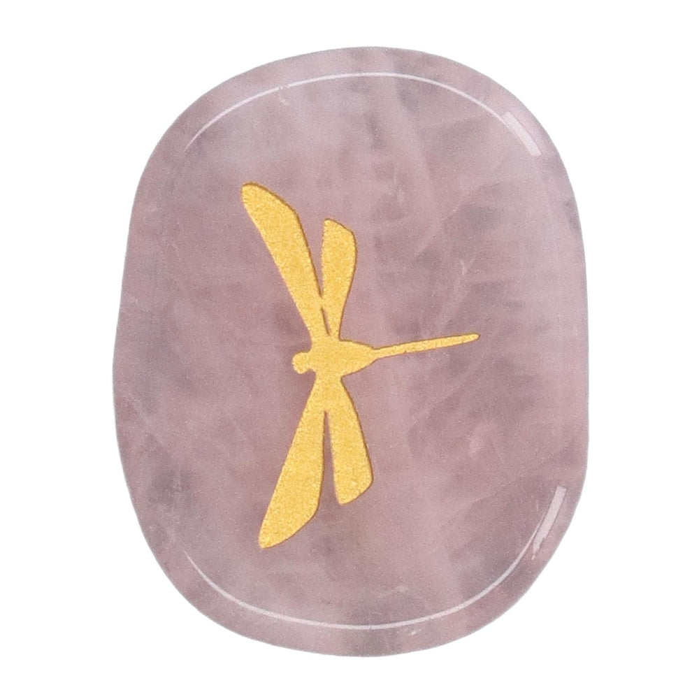 Gold dragonfly detail shines on the palm-sized healing stone's smooth surface.