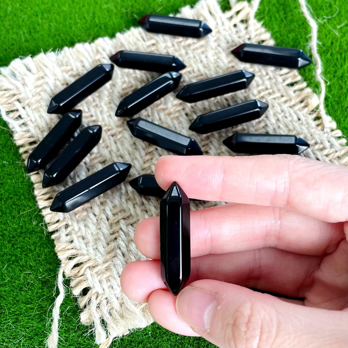 ZHIYUXI obsidian pointed stone held in hand for calm focus.