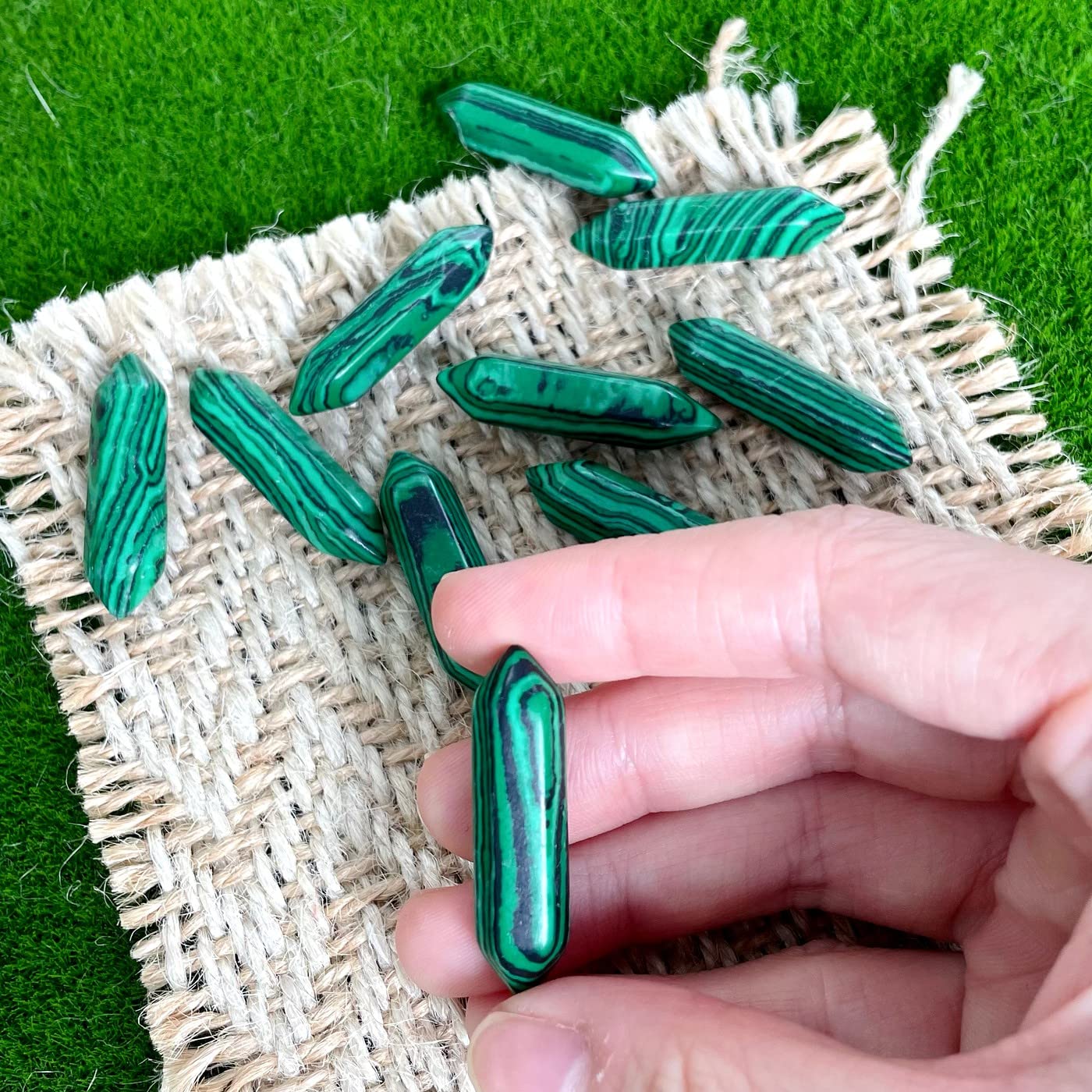 Close-up of ZHIYUXI Malachite wand reveals natural banding and energy focus