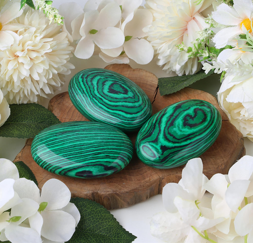 ZHIYUXI Malachite palm stone used in meditation setup with smooth polish.