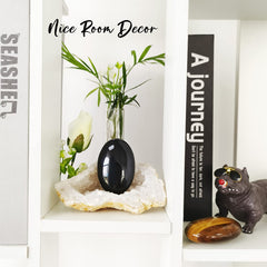 ZHIYUXI obsidian decor palm stone adds a serene room accent.