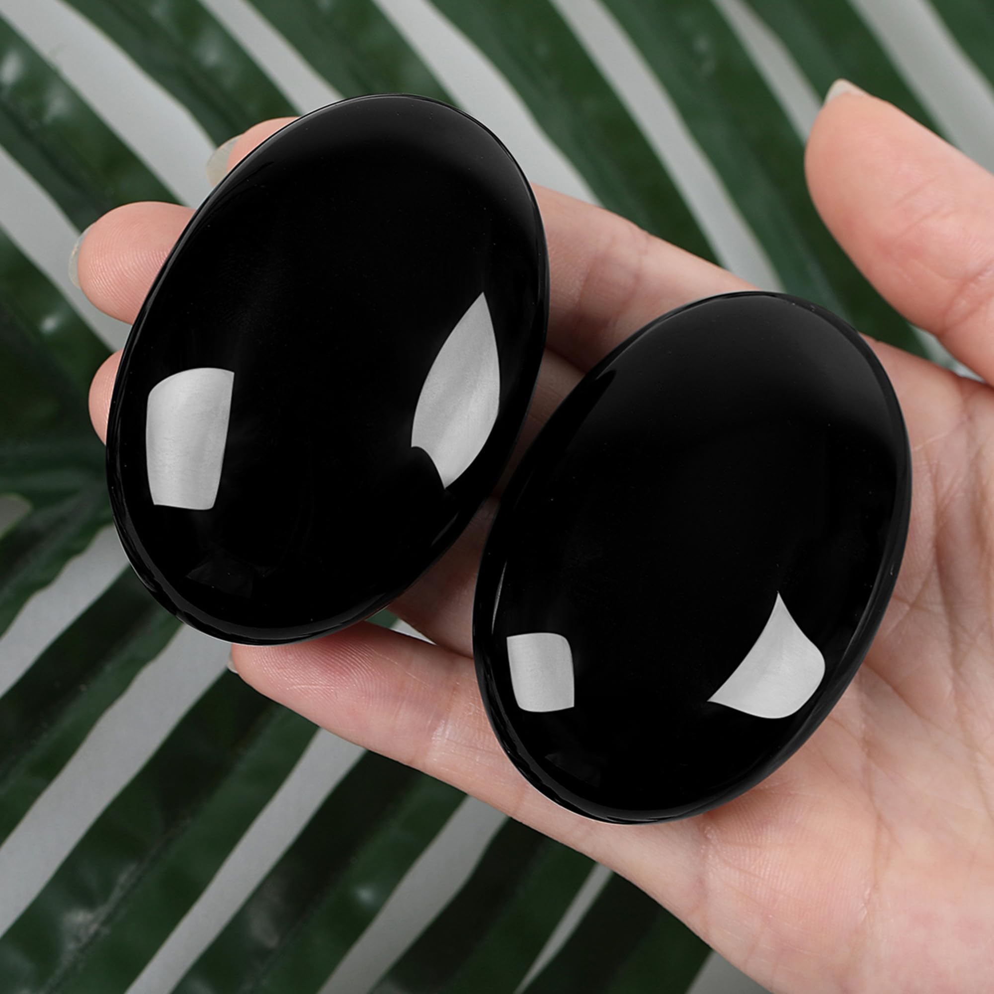 ZHIYUXI obsidian palm stone close-up highlighting natural texture and shine.
