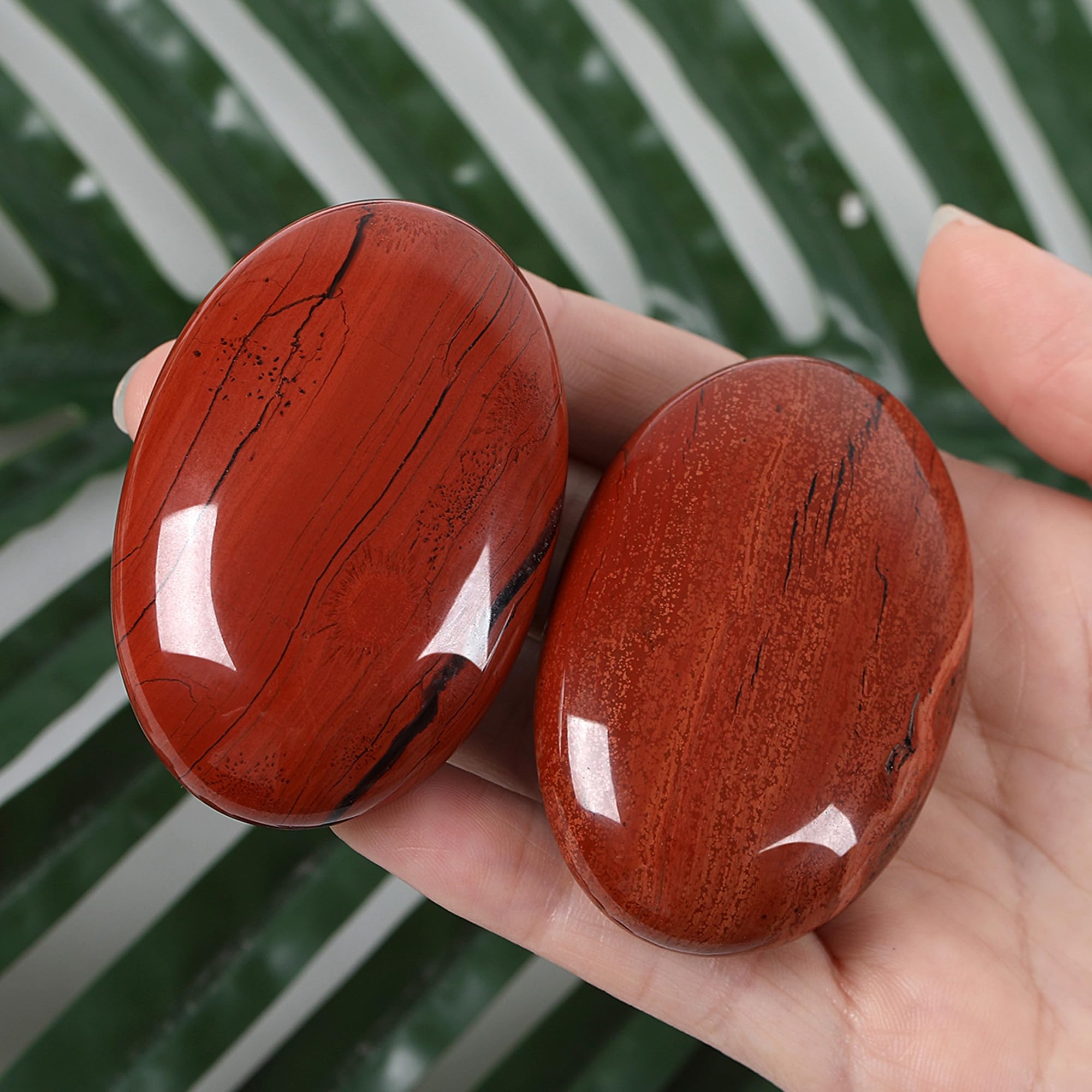 ZHIYUXI red Jasper palm stone on a desk decor promoting energy balance at work.