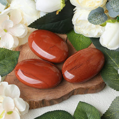 ZHIYUXI palm stone held during yoga for grounding and concentration with red jasper.