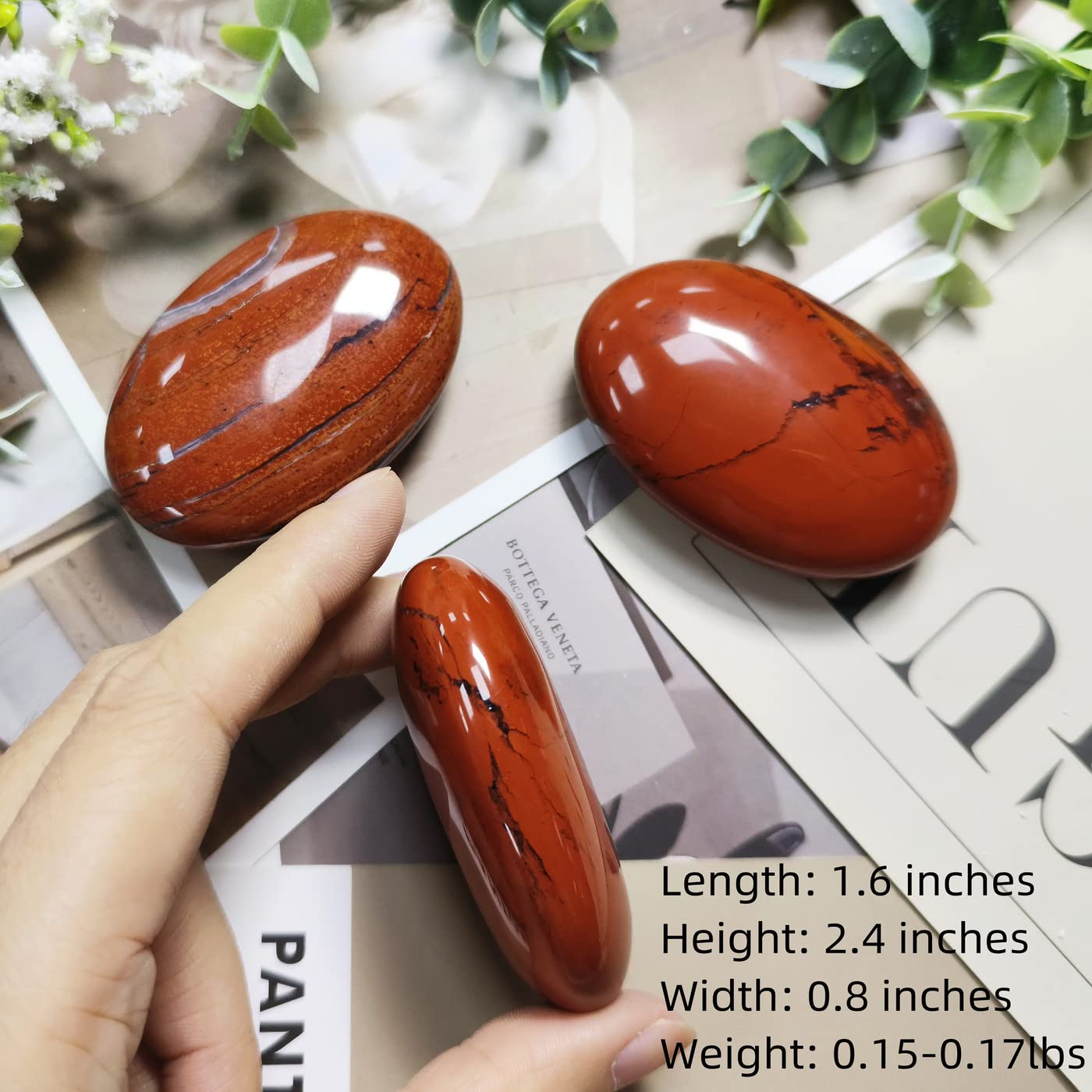 ZHIYUXI red Jasper palm stone on a shelf enhancing room ambience.