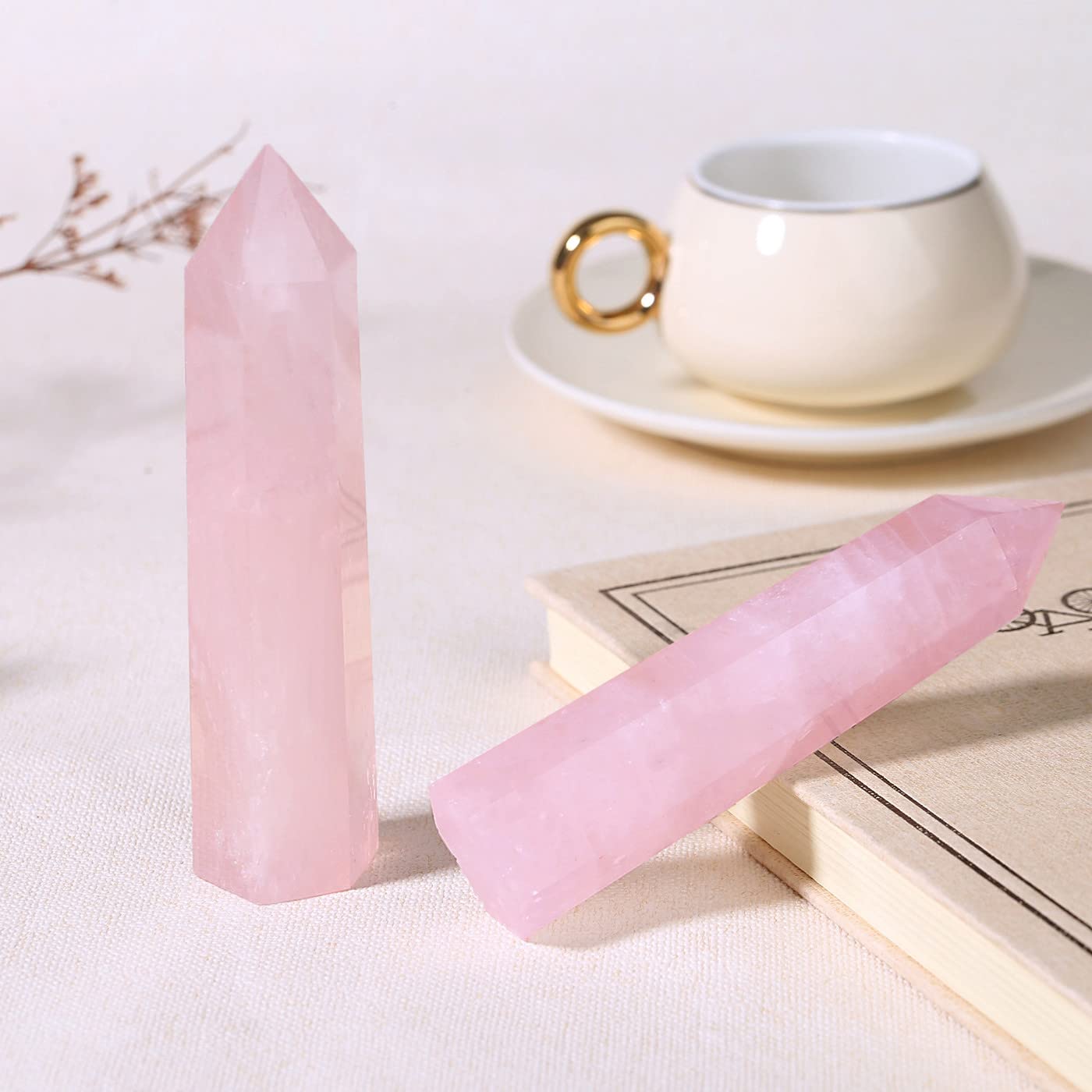 ZHIYUXI rose quartz crystal tower displayed on a shelf.